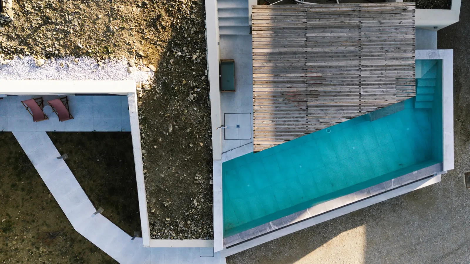 Aerial view over the infinity pool and all three houses